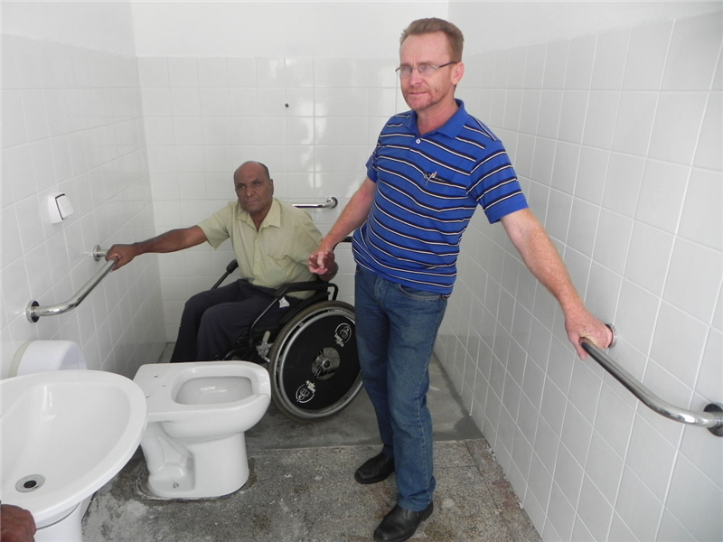 Joi e José Bráz dos Santos em banheiro com acessibilidade do Centro de Especialidades.